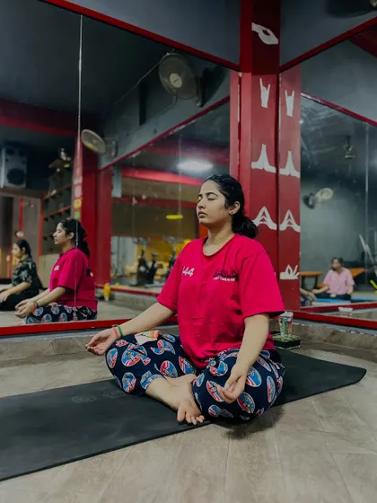 'Sthirasukham asanam'. The pose should be steady and comfortable. A student finds her peaceful seat in meditation.