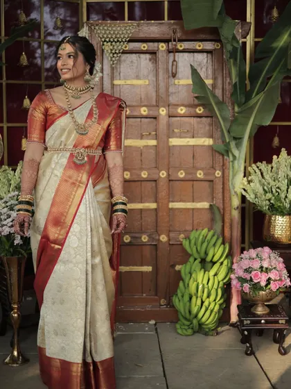 A full-length view of the bride in her stunning South Indian attire. The makeup is kept elegant and classic to match the grandeur of the occasion.
