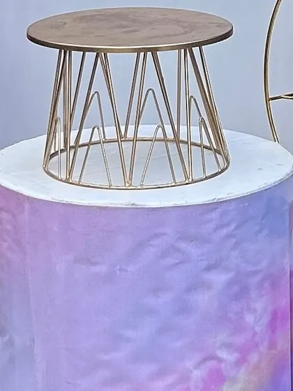 A themed pedestal with a pastel, watercolor-style print, topped with a modern gold wire cake stand. This shows how I coordinate all elements of the decor.
