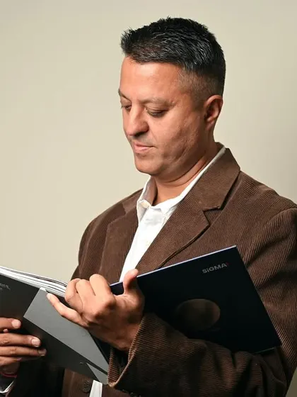 A candid-style shot of a CEO reviewing a document. This type of "in-action" portrait conveys diligence, expertise, and a commitment to quality.