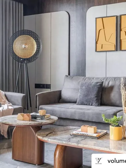 This corner of the living room shows the layering of textures and forms. The sculptural floor lamp, nested marble coffee tables, and soft textiles come together to create a space that feels curated, comfortable, and full of character.