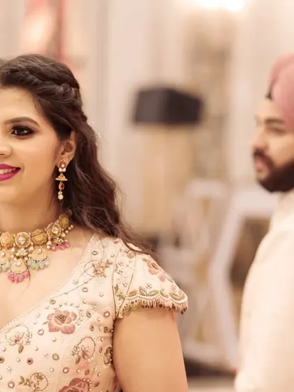 The groom looks on as his bride-to-be shines. This candid shot during their engagement ceremony captures a story of admiration and love.