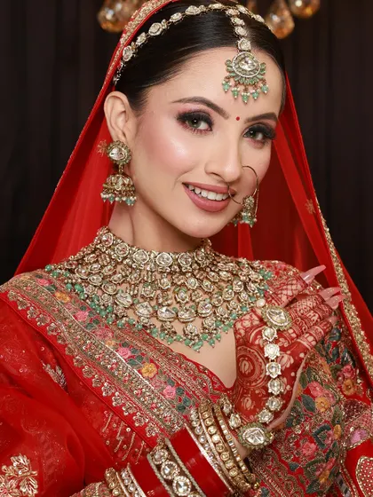 A smiling bride looking radiant in her wedding attire, with her mehandi adding a touch of traditional elegance.