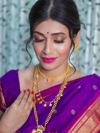 The focus here is on the flawless, radiant skin and the soft, shimmery eye makeup that makes her eyes pop.