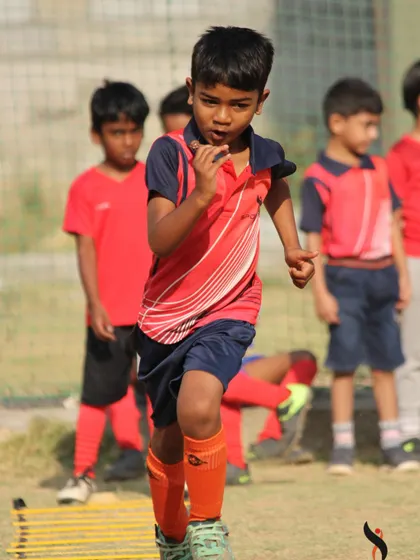 A duplicate of image 52, capturing the intensity and effort of a young athlete during a summer camp speed and agility exercise.