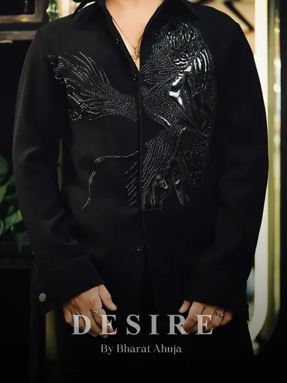 A close-up of the black-on-black embroidered phoenix shirt. The texture and detail are subtle yet incredibly luxurious.