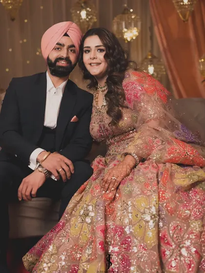 A beautiful portrait of the couple on their Sangeet night. His classic suit and her floral lehenga are a perfect match.