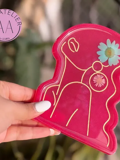 This premium resin trinket tray in a vibrant pink is perfect for organizing your bedside table or office desk in style.