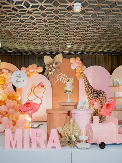 A vibrant and playful safari theme for a third birthday. We used pink and orange tones, along with a flamingo and giraffe, to create a unique "Pink Safari" concept.