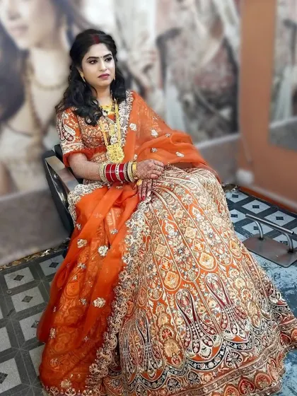 A beautiful bride in a stunning orange and gold lehenga. I created a warm, golden makeup look to complement her outfit, focusing on glowing skin and defined features.