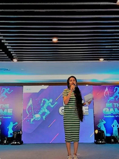 On stage, mid-event, at the Dell "Be The Game" grand finale. My role is to keep the momentum going, explain the activities clearly, and cheer on the participants as they compete.