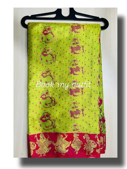 A full view of the lime green silk saree, showcasing the unique pattern of dancing figures along the pink and gold border.