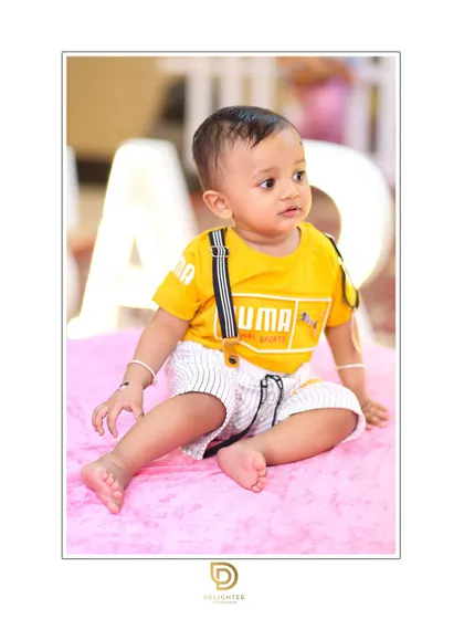 A classic seated portrait that is perfect for first birthday announcements and family albums.