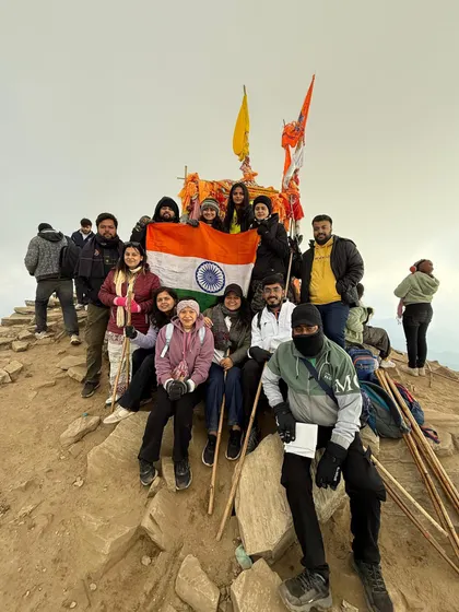 The entire group together at the Chandrashila trek summit. These group photos capture the camaraderie and shared experience of reaching the top as a team.