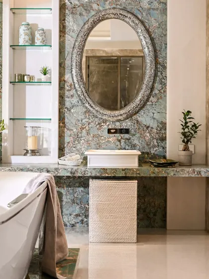 A detailed shot of the vanity area. The natural patterns in the marble create a unique piece of art on their own. We kept the accessories minimal to let the beauty of the stone be the main feature.
