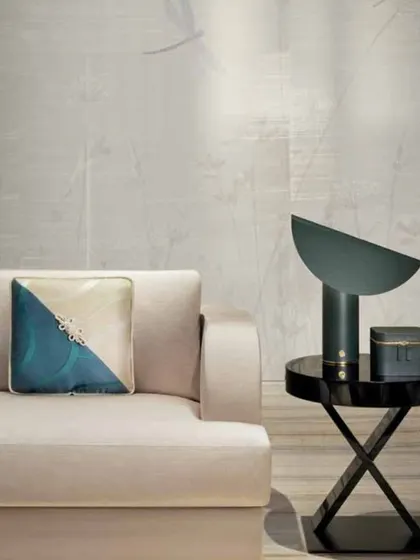 The Armani Casa 'Inspired Mood' collection embodies a world of quiet sophistication. Here, a subtle wallcovering with a delicate sheen provides a perfect backdrop for minimalist furniture, showcasing how texture and light can create an atmosphere of refined luxury.