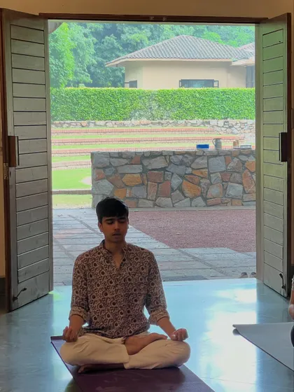 Our yoga retreats offer a chance to disconnect from the rush of life and reconnect with yourself. Here, a student finds a moment of peace and meditation, surrounded by the tranquility of nature.