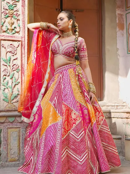The wait is over! This patchwork-style lehenga in shades of pink and orange is inspired by the timeless charm of Chandni Chowk. It’s a celebration of color and tradition.