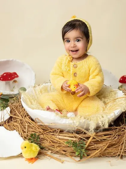 This little chick is so happy with her new toy. The simple, clean background allows the bright colors and her joyful expression to take center stage.
