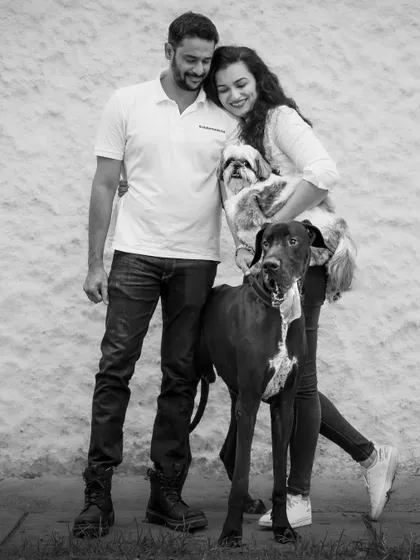 A full-length black and white family portrait, showcasing the different sizes and personalities of this happy group.