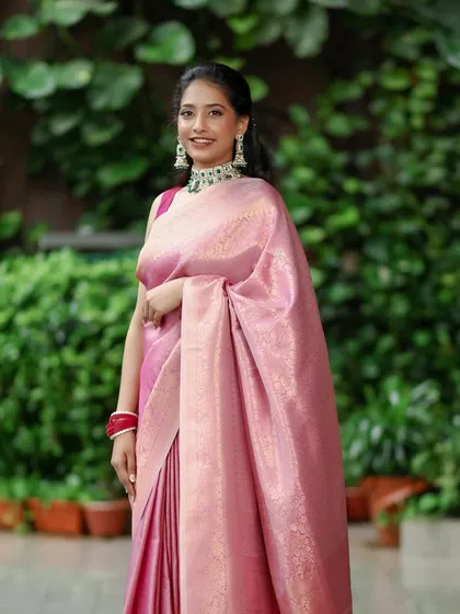 A full-length view of this graceful engagement bride. The makeup, hair, and saree draping all work in harmony to create a look of timeless South Indian elegance.