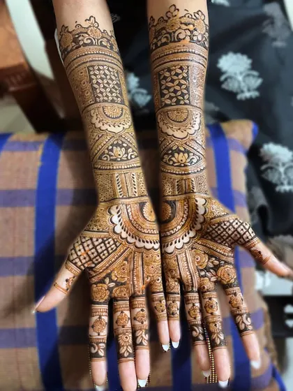 Here is another example of a full-coverage bridal design, perfect for the bride who wants her hands completely adorned. The patterns are a mix of floral, paisley, and geometric elements.