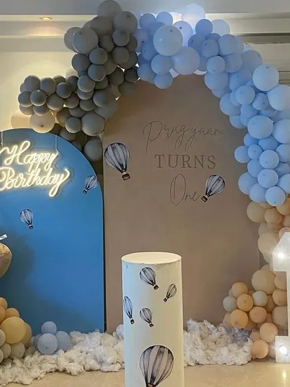 A soft and gentle Hot Air Balloon and Teddy Bear theme, using pastel blue and peach balloons with cloud effects on the floor.
