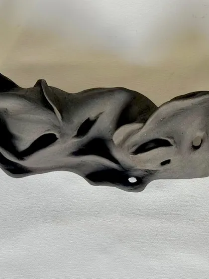 This abstract sculpture was created by hand, exploring organic forms and movement. It's a piece that invites you to look closer and find your own meaning.