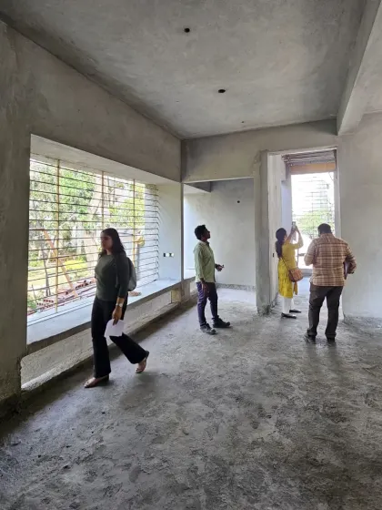The team and clients walking through the expansive, raw interior space of Villa 14.