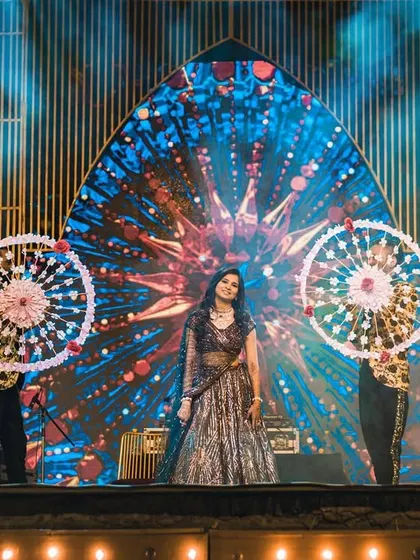 We use creative props, like these ornate umbrellas, to add a unique visual element to solo and group performances, making them stand out.