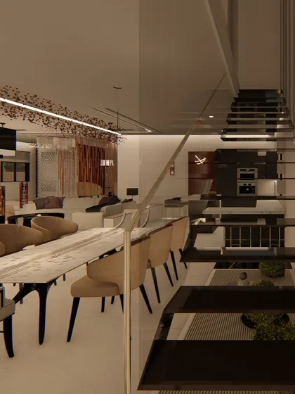 A view of the dining and living area from the staircase, showing the open and connected nature of the floor plan. The design prioritizes flow and visual continuity between spaces.