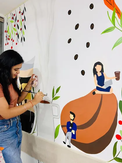 Another shot of me painting the coffee-themed mural, adding details to the giant coffee bean and the character sitting on it.