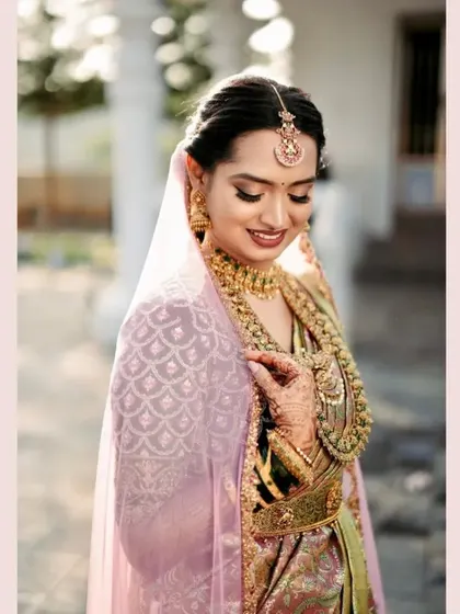 A bride embracing tradition in a beautiful green blouse with intense hand embroidery.
