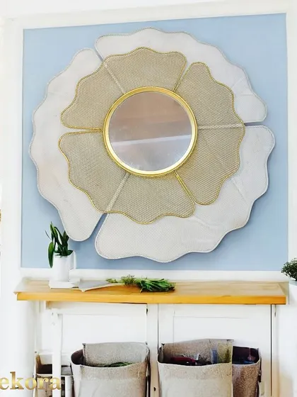 A large, abstract flower-shaped mirror with white and mesh-textured petals. This unique piece is perfect for an entryway or hallway, creating a bright and welcoming focal point.