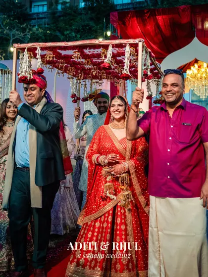 The bride's processional, escorted by her brothers under a beautiful floral 'phoolon ki chadar'.