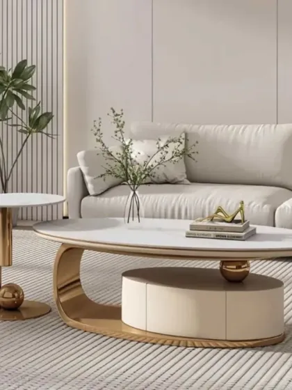 A luxurious center table set with a white top and a gold-finished base. The design includes a clever integrated storage compartment, combining elegance with practicality.