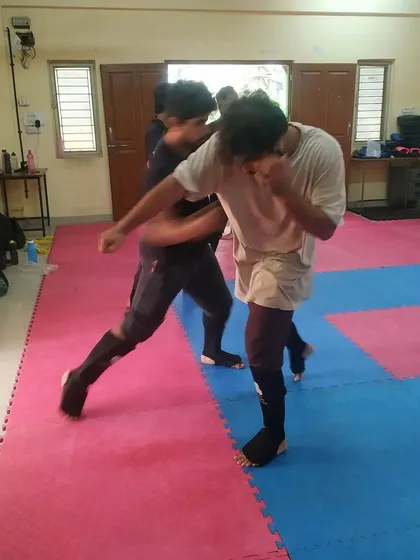 Two students sparring on the mats. This is where they learn to manage distance, timing, and pressure in a live but controlled setting.