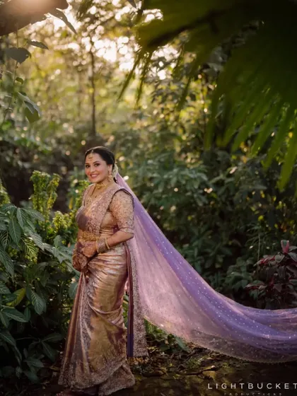 The bride's flowing purple veil creates a beautiful, ethereal effect in this portrait.