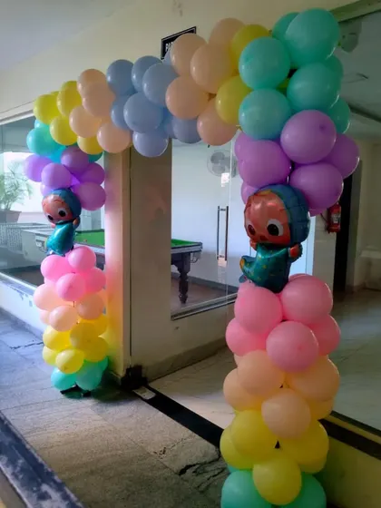 A simple yet fun entrance arch for a Cocomelon party, using pastel balloons and character foil balloons.