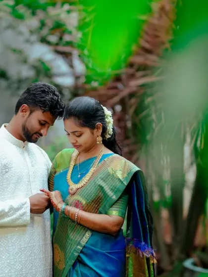 A tender moment between a couple surrounded by lush greenery. These quiet, candid shots are often the most powerful.