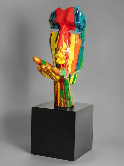 This striking sculpture of a face with a hand blowing a kiss is finished in a rainbow of colors. It's an expressive and modern piece that adds a burst of energy and affection to your decor.