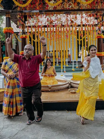 The energy is infectious! Family and friends dancing with joy at a traditional Haldi ceremony, set within a beautifully decorated mandap.