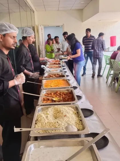 Our staff assisting employees at the IQVIA office cafeteria. We focus on providing attentive and professional catering service throughout your event.