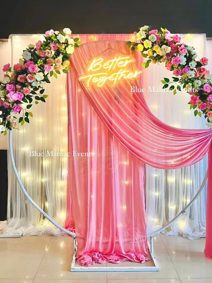 The same pink-themed Roka backdrop shown without the sofa, highlighting the full ring frame and the elegant draping. This is a versatile piece for various events.