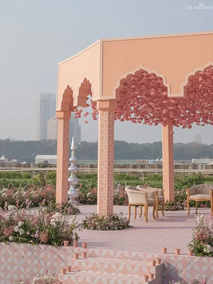 The mandap stage, with its custom-printed pink floor and a canopy of flowers, creating a space that is both grand and romantic.
