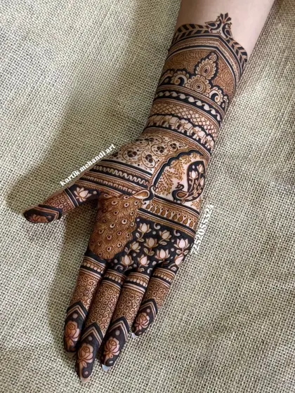 A classic Indian traditional mehandi design. This single-hand pattern features a prominent peacock, lotus motifs, and a beautiful cuff, perfect for any festive occasion.