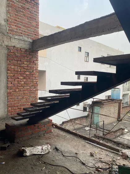Another angle of the cantilevered metal staircase, showing how it is anchored to the building's structure to create a "floating" effect.