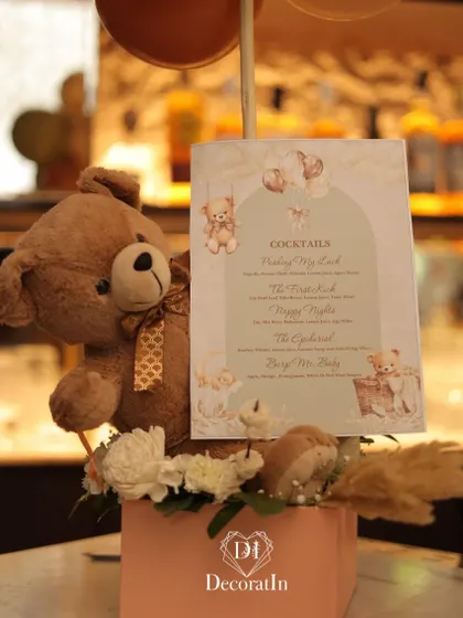 A close-up of the teddy bear holding the themed cocktail menu.