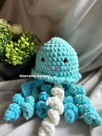 A full view of the handmade octopus toy. Made with baby-safe yarn, it's a gentle and soothing companion for newborns and a perfect baby shower gift.