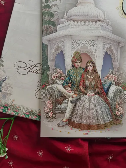 A close-up of the royal couple illustration from the pastel invitation, highlighting the delicate colors and intricate details.